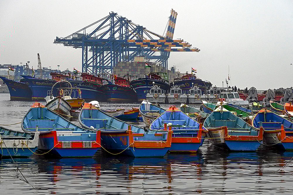 | Photo: PTI : Fishing boats remain anchored against the backdrop of Vizhinjam International Seaport in the wake of bad weather and the impact of cyclonic storm Ditwah, in Thiruvananthapuram.