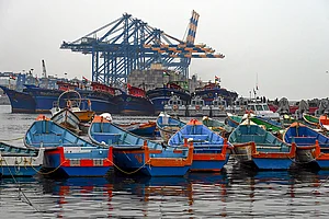 | Photo: PTI : Fishing boats remain anchored against the backdrop of Vizhinjam International Seaport in the wake of bad weather and the impact of cyclonic storm Ditwah, in Thiruvananthapuram.