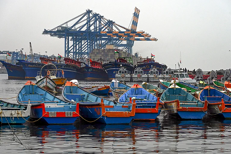 Fishing boats remain anchored against the backdrop of Vizhinjam International Seaport in the wake of bad weather and the impact of cyclonic storm Ditwah, in Thiruvananthapuram. - | Photo: PTI