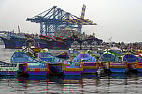 | Photo: PTI : Fishing boats remain anchored against the backdrop of Vizhinjam International Seaport in the wake of bad weather and the impact of cyclonic storm Ditwah, in Thiruvananthapuram.