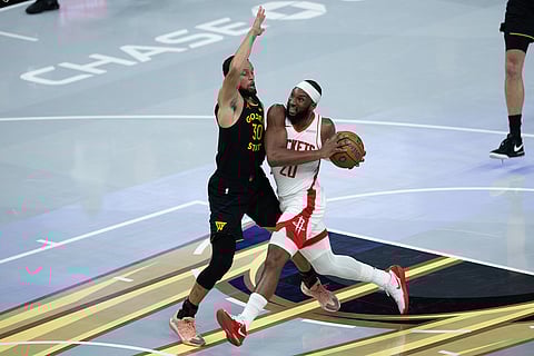 Houston Rockets guard Josh Okogie is guarded by Golden State Warriors guard Stephen Curry during the first half of an Emirates NBA Cup basketball game in San Francisco. 