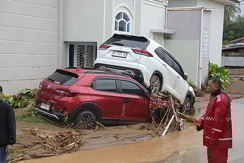People inspect the damage at a flood hit neighborhood  in Padang, West Sumatra, Indonesia. 