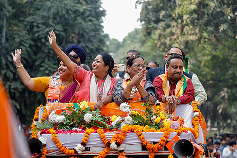 Delhi Chief Minister Rekha Gupta joins BJP candidate Veena Asija during a road show at Ashok Vihar constituency, in New Delhi. 