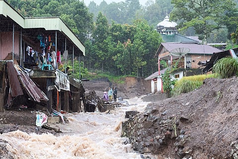 Residents inspect the damage after a flood in Malalak, West Sumatra, Indonesia.