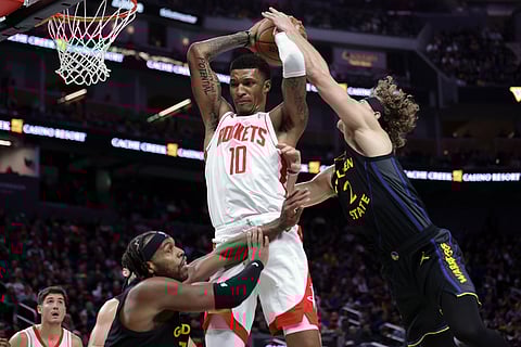 Golden State Warriors' Brandin Podziemski fouls Houston Rockets' Jabari Smith, Jr. during the second half of an Emirates NBA Cup basketball game in San Francisco.