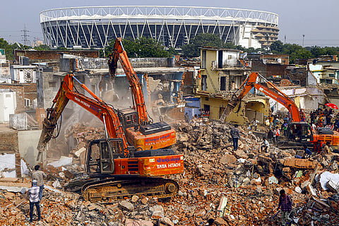Excavators being used to demolish residential buildings near the Narendra Modi Stadium as part of a drive by municipal corporation, in Ahmedabad. Ahmedabad was formally awarded the hosting rights for Commonwealth Games 2030 recently. 