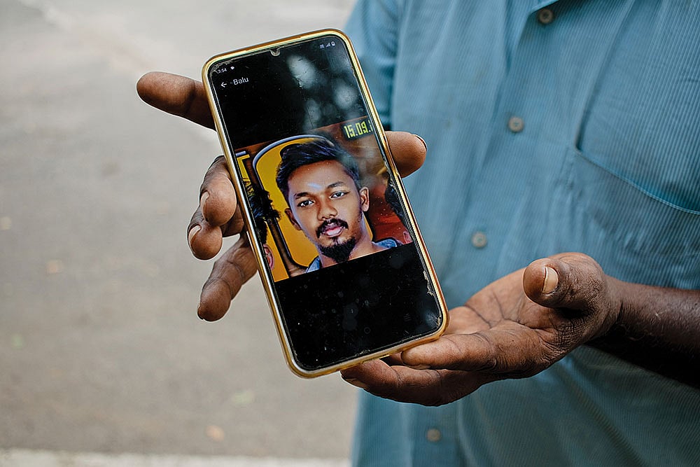 Faces of Tragedy: Chinnakannu shows the picture of his son - | Photo: Subash Sagar