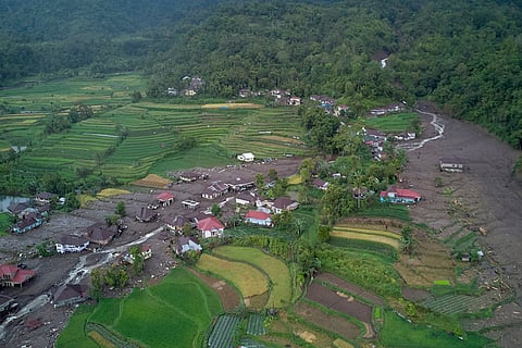 This aerial photo taken using a drone shows a village devastated by a flood in Malalak, West Sumatra, Indonesia.