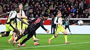 Photo: Federico Gambarini/dpa via AP : Bayer Leverkusen Vs Borussia Dortmund Highlights, Bundesliga: Malik Tillman, centre, and Serhou Guirassy fight for the ball.