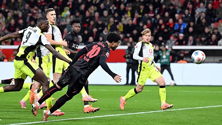Bayer Leverkusen Vs Borussia Dortmund Highlights, Bundesliga: Malik Tillman, centre, and Serhou Guirassy fight for the ball. - Photo: Federico Gambarini/dpa via AP