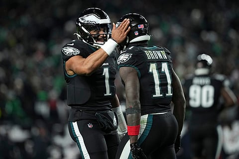 Philadelphia Eagles wide receiver A.J. Brown (11), right, celebrates his touchdown with quarterback Jalen Hurts (1) during the second half of an NFL football game against the Chicago Bears in Philadelphia. 