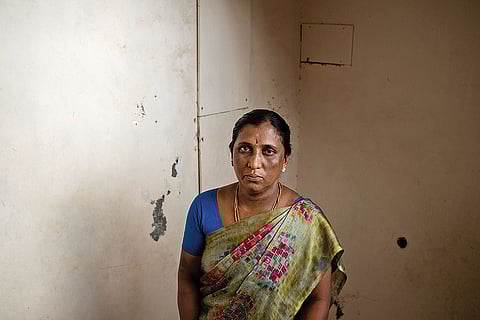 Muthu, who lives in a Dalit colony near Madurai, in front of his dilapidated house