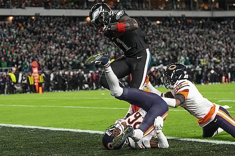 Philadelphia Eagles wide receiver A.J. Brown (11) jumps over Chicago Bears cornerback Nahshon Wright (26) to score a touchdown during the second half of an NFL football game in Philadelphia. 