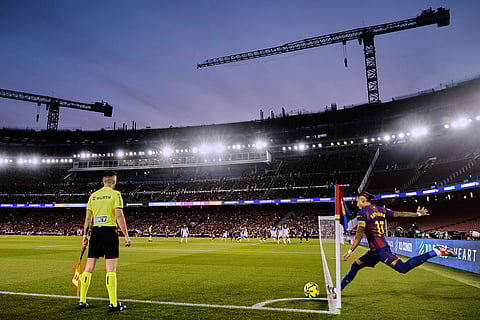 Barcelona's Raphinha, right, takes the corner kick during a Spanish La Liga soccer match between Barcelona and Alaves, in Barcelona, Spain.