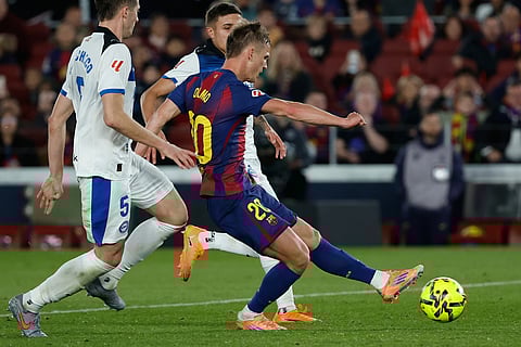 Barcelona's Dani Olmo scores his side's third goal during a Spanish La Liga soccer match between Barcelona and Alaves, in Barcelona, Spain.