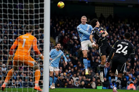Manchester City's Erling Haaland, top left, heads the ball during the English Premier League soccer match between Manchester City and Leeds United at Etihad Stadium, Manchester, England.
