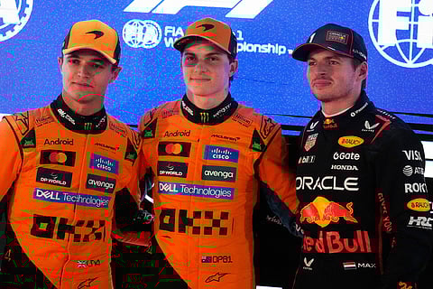 McLaren driver Oscar Piastri of Australia, pole position, center, is flanked by second best time McLaren driver Lando Norris of Britain, and Red Bull driver Max Verstappen of the Netherlands after the second qualifying session at the Lusail International Circuit ahead of the Qatar Formula One Grand Prix, in Lusail, Qatar.