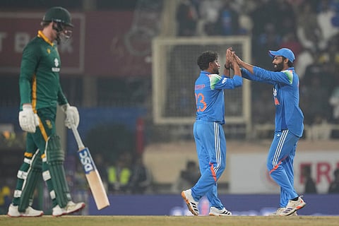 India's Kuldeep Yadav, centre, celebrates the wicket of South Africa's Prenelan Subrayen during the first One Day International match between India and South Africa in Ranchi.