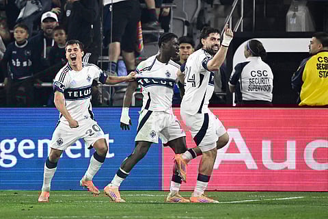 Vancouver Whitecaps forward Brian White (24), right, celebrates after scoring next to Emmanuel Sabbi (11), center, and Andrés Cubas (20) during the first half of an MLS Western Conference final soccer match against San Diego FC in San Diego. 