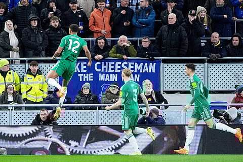 Newcastle United's Malick Thiaw, left, celebrates scoring during the English Premier League soccer match between Everton and Newcastle United in Liverpool, England.