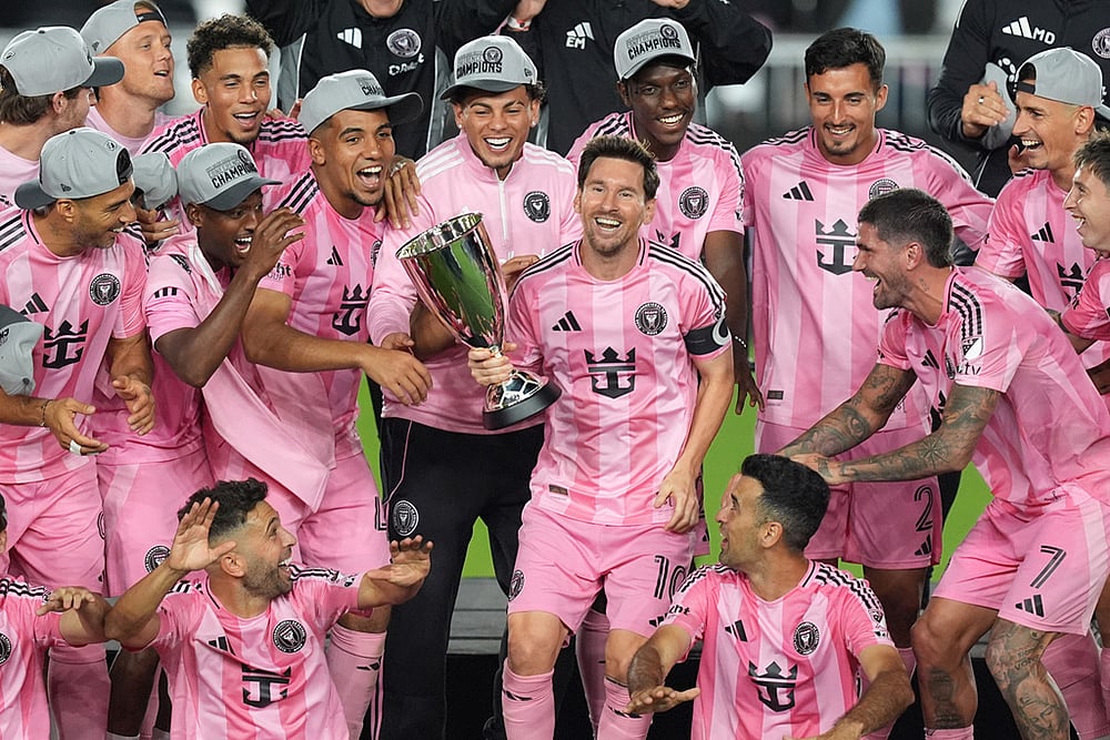 Inter Miami forward Lionel Messi (10) holds the trophy as Inter Miami players celebrate winning an MLS Eastern Conference final soccer match against New York City FC, in Fort Lauderdale, Florida.  - | Photo: AP/Rebecca Blackwell