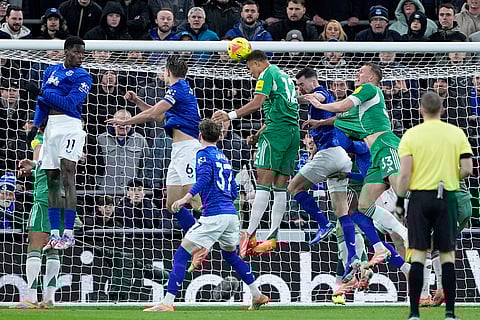 Newcastle United's Malick Thiaw, center, scores during the English Premier League soccer match between Everton and Newcastle United in Liverpool, England.