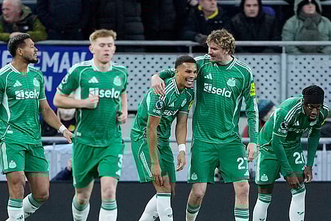 Newcastle United's Malick Thiaw, center, celebrates scoring with teammates during the English Premier League soccer match between Everton and Newcastle United in Liverpool, England.
