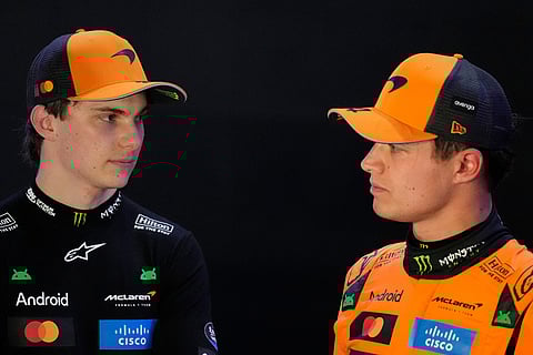McLaren driver Oscar Piastri of Australia, pole position, looks to McLaren driver Lando Norris of Britain, after the second qualifying session at the Lusail International Circuit ahead of the Qatar Formula One Grand Prix, in Lusail, Qatar.