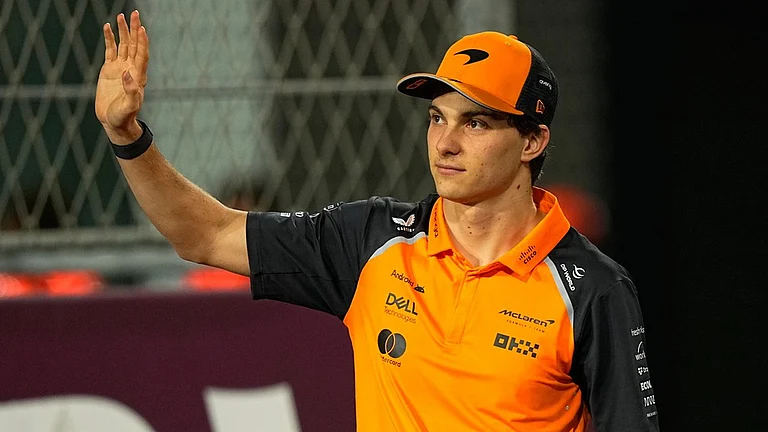 Qatar Grand Prix Live Updates: McLaren driver Oscar Piastri of Australia waves to supporters during the driver's parade. - Photo: AP