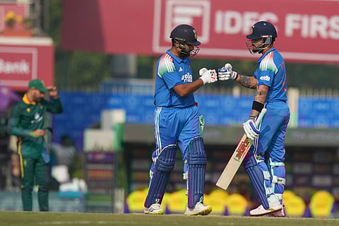 India's Virat Kohli, right, and India's Rohit Sharma give the fist after scoring runs during the first One Day International match between India and South Africa in Ranchi.