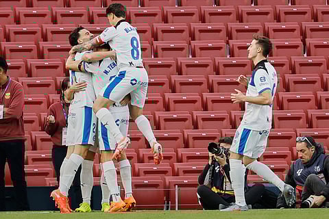 Alaves' Pablo Ibanez, left, celebrates after scoring the opening goal during a Spanish La Liga soccer match between Barcelona and Alaves, in Barcelona, Spain.