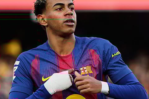 Barcelona's Lamine Yamal celebrates after scoring his side's first goal during a Spanish La Liga soccer match between Barcelona and Alaves, in Barcelona, Spain.