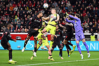 | Photo: Federico Gambarini/dpa via AP : Bayer's Loïc Badé, center left, and Borussia's Nico Schlotterbeck fight for the ball during the German Bundesliga soccer match between Bayer Leverkusen and Borussia Dortmund in Leverkusen, Germany.