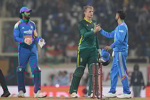 India's Virat Kohli, right, shakes hands with South Africa's Corbin Bosch after India won the first One Day International match in Ranchi.