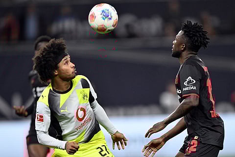 Bayer's Edmond Tapsoba, right, and Borussia's Karim Adeyemi fight for the ball during the German Bundesliga soccer match between Bayer Leverkusen and Borussia Dortmund in Leverkusen, Germany.