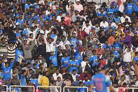 Fans cheers after India's Virat Kohli score fifty runs during the first One Day International match between India and South Africa in Ranchi.
