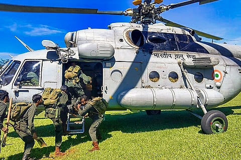 Indian Air Force personnel board a helicopter to evacuate stranded passengers from cyclone-hit Sri Lanka. 