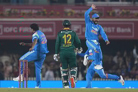 India's Virat Kohli, right, and India's Harshit Rana, left, celebrates the wicket of South Africa's Quinton de Kock , centre, during the first One Day International match between India and South Africa in Ranchi.