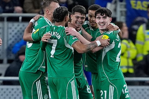 Newcastle United's Lewis Miley, center, celebrates scoring with teammates during the English Premier League soccer match between Everton and Newcastle United in Liverpool, England.