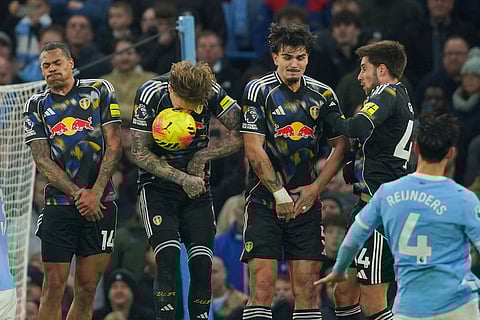Leeds players go up to block a free kick by Manchester City's Tijjani Reijnders during the English Premier League soccer match between Manchester City and Leeds United in Manchester, England.