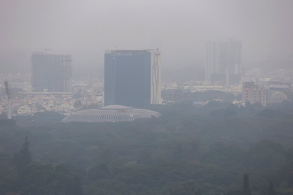 An aerial view of the city under cloudy skies, in Bengaluru. The weather remains affected as Cyclone Ditwah influences conditions across neighbouring states.  - | Photo: PTI