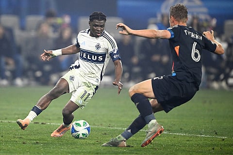 San Diego FC defender Jeppe Tverskov (6) defends against Vancouver Whitecaps forward Emmanuel Sabbi (11) during the second half of an MLS Western Conference final soccer match in San Diego. 