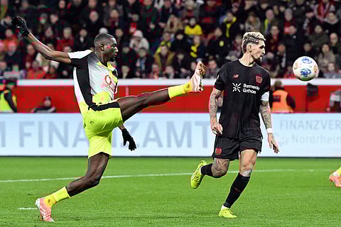 Bayer's Robert Andrich, right, and Borussia's Serhou Guirassy fight for the ball during the German Bundesliga soccer match between Bayer Leverkusen and Borussia Dortmund in Leverkusen, Germany.