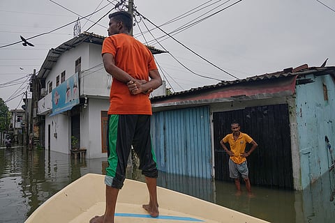 A volunteer searches for needy people in a flooded area in Colombo, Sri Lanka.
