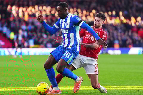 Brighton and Hove Albion's Danny Welbeck, left and Nottingham Forest's Neco Williams vie for the ball, during the English Premier League soccer match between Nottingham Forest and Bright and Hove Albion,  at the City Ground, in Nottingham, England.