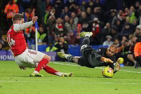 Chelsea's goalkeeper Robert Sanchez, right, makes a save ahead of Arsenal's Viktor Gyoekeres during the English Premier League soccer match between Chelsea and Arsenal in London, England.