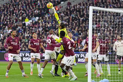 West Ham's goalkeeper Alphonse Areola makes a safe during the English Premier League soccer match between West Ham United and Liverpool in London.