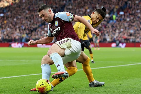 Aston Villa's John McGinn, left and Wolverhampton Wanderers' Joao Gomes vie for the ball, during the English Premier League soccer match between Aston Villa and Wolverhampton Wanderers, at Villa Park, in Birmingham, England.