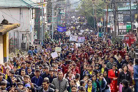 Students from various schools and colleges, along with others, take part in an anti-drug walkathon, in Dharamshala.