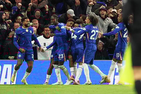 Chelsea's Trevoh Chalobah, centre, celebrates after scoring his side's opening goal during the English Premier League soccer match between Chelsea and Arsenal in London, England.
